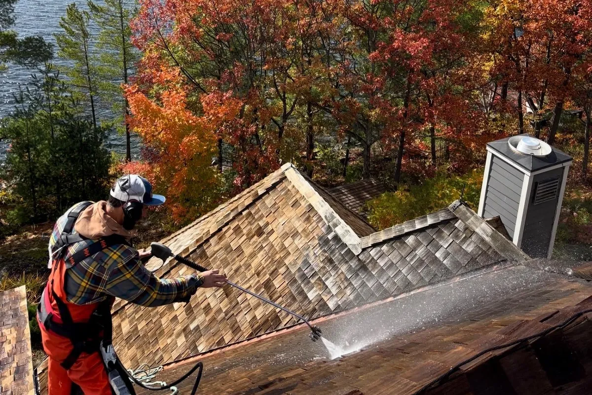 Professional cedar roof cleaning in progress