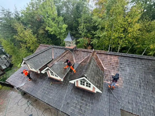 Brite team pressure washing a roof in Huntsville